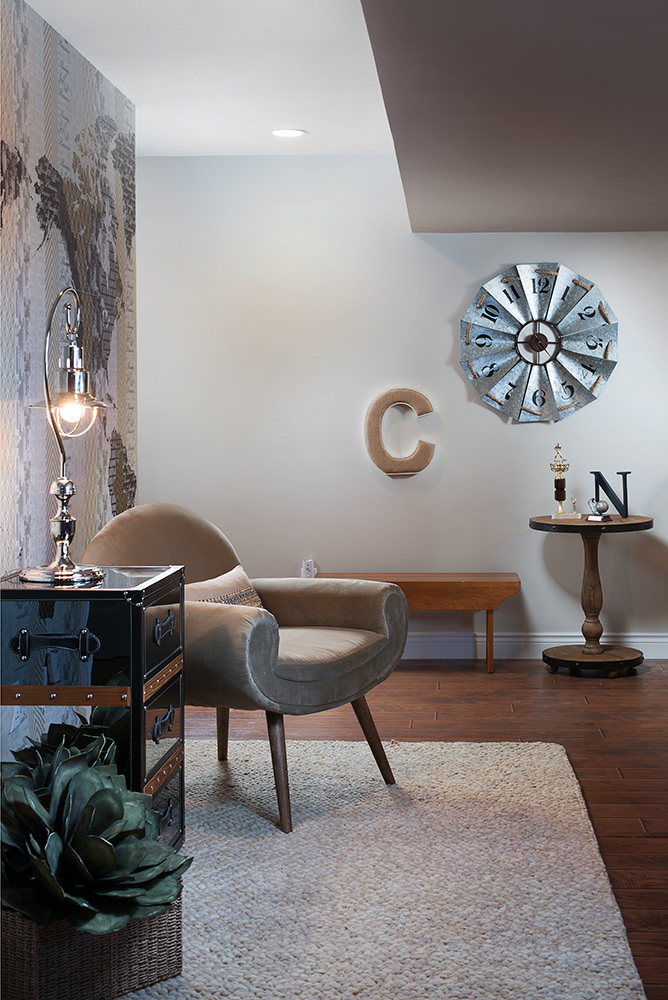 basement remodel with stylish wallpaper and chair by decorating den - interior photographer